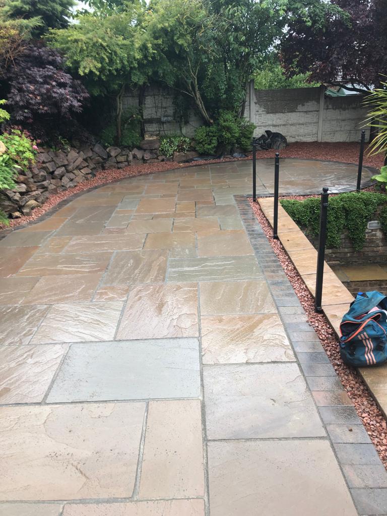 Indian sandstone patio with rustic gold block-paved border